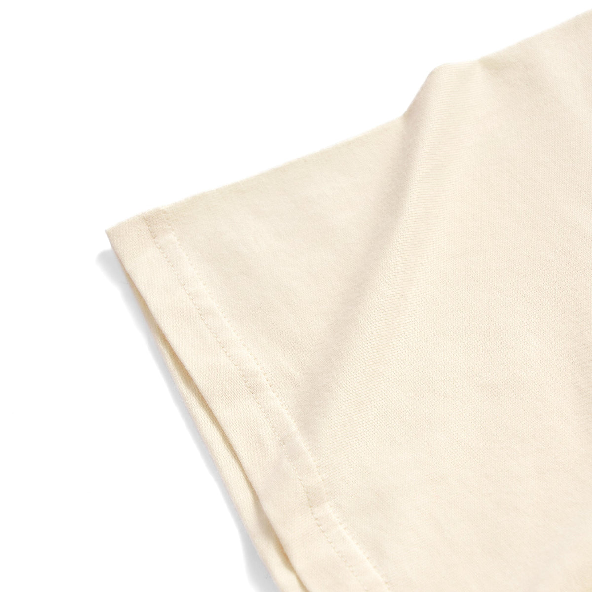 A close-up of a light cream or off-white fabric sleeve with neat stitching, shown against a solid white background.