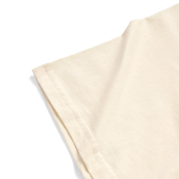 A close-up of a light cream or off-white fabric sleeve with neat stitching, shown against a solid white background.